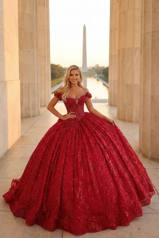 Woman in red ball gown with gold accents, off-shoulder design, elegant formal dress